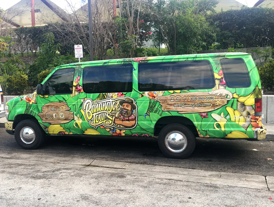 Full wrap on a passenger van with a printed tropical graphic and company logo