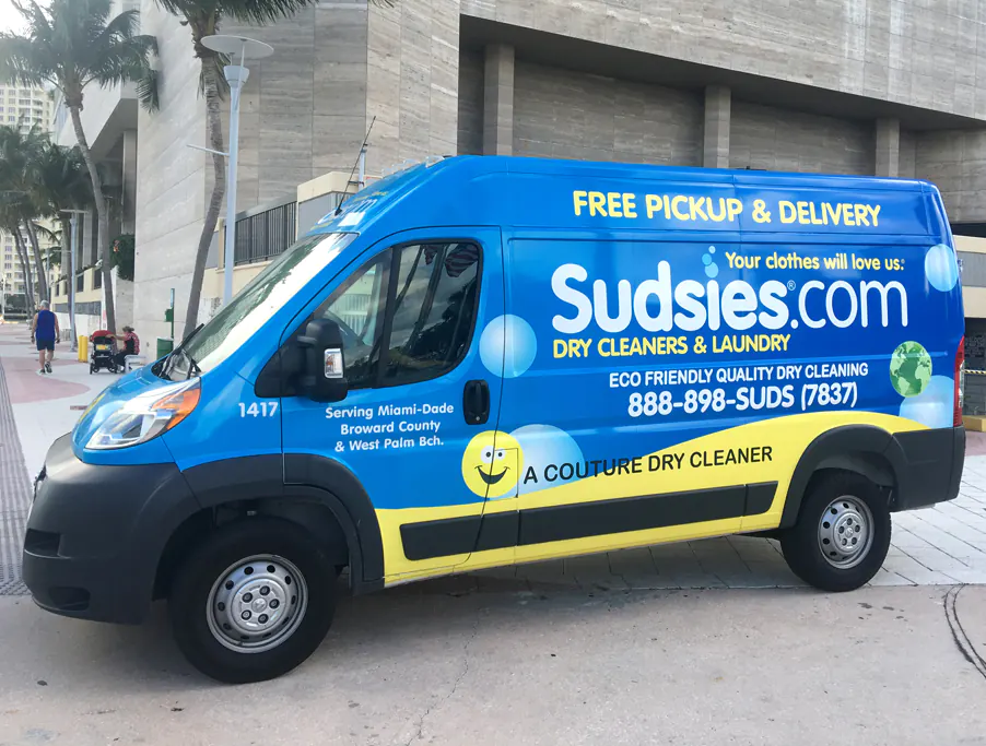 Blue and yellow full wrap on a cargo van advertising a dry cleaning and laundry service